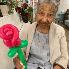 assistant living resident with rose.jpg